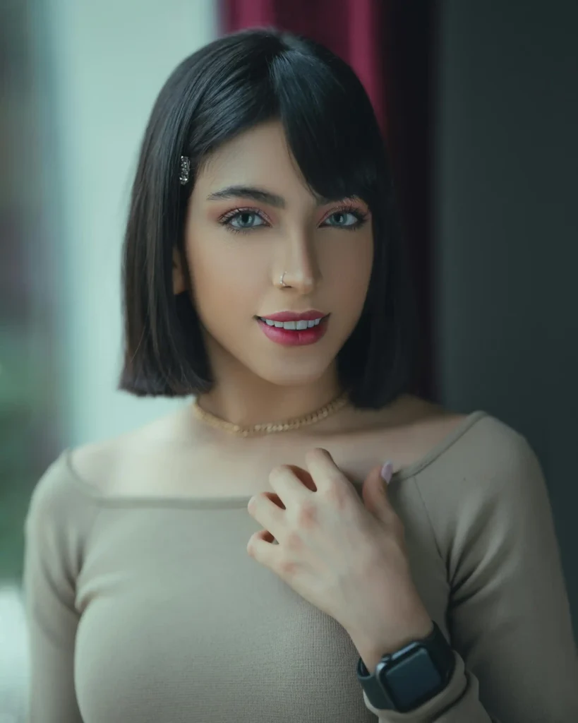 A woman with a voluminous Italian Bob haircut featuring a deep side part and soft waves.