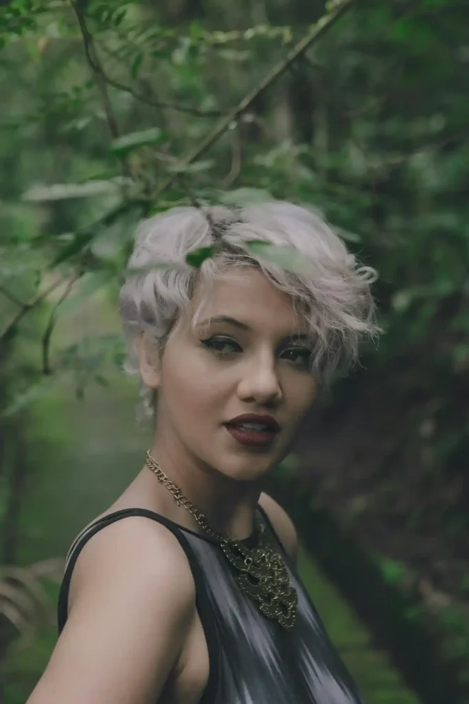 A sophisticated model showcasing a high-shine Glass Pixie cut with sharp, polished edges.